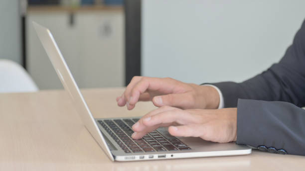 istock Side View of Businessman Working on Laptop 1493545253