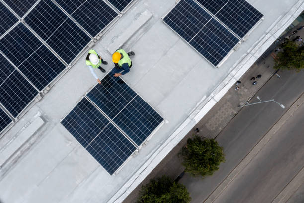 istock Team of engineers installing solar panels on a rooftop 1493545275