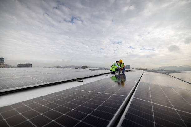 istock Engineers supervising the operation of solar panels on a green building 1493545345