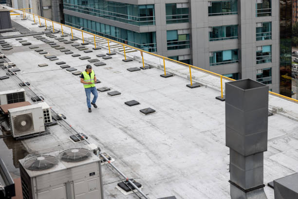 Maintenance engineer doing a routine inspection on the rooftop of a building