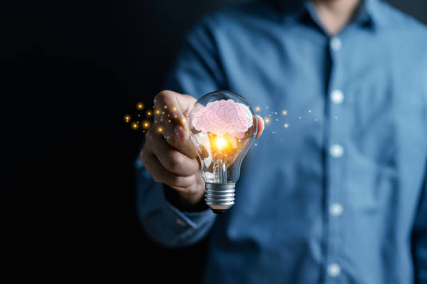 istock Businessman hand holding light bulb with brain into smart, creative, idea thinking to innovation brainstorm and imagination learning educate concept. 1493545750