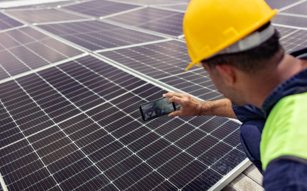 istock Engineer reading the efficiency of a solar power station using a cell phone 1493545856