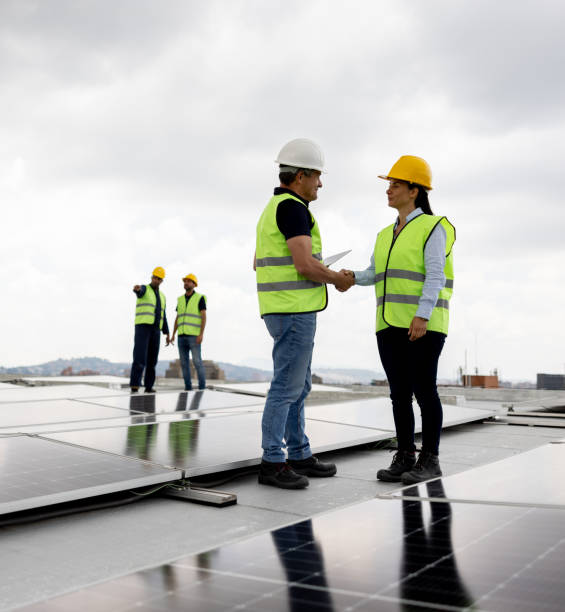 istock Foreman handshaking with an engineer while installing solar panels of a rooftop 1493546040