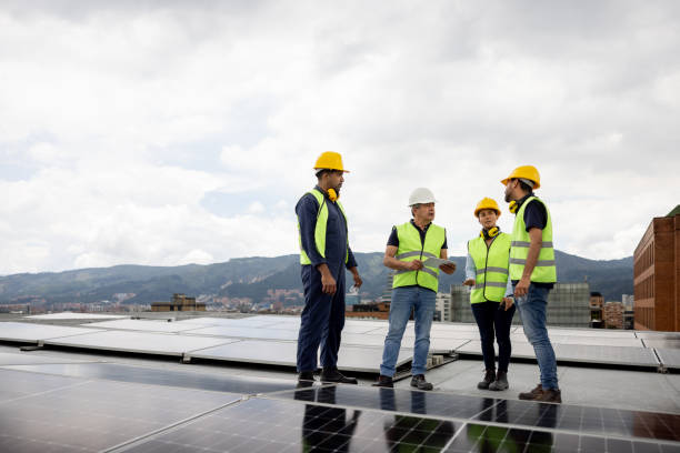 istock Team of power engineers installing solar panels on a rooftop 1493546383