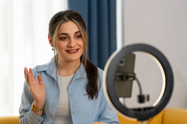 istock Smiling young woman female influencer doing a vlog post at home 1493548613
