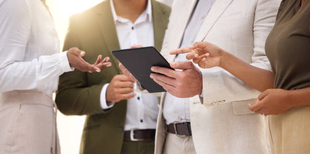 istock Hands, tablet and collaboration with a business team working on research together in their office. Teamwork, meeting or planning with a man and woman employee group discussing strategy at work 1493549085
