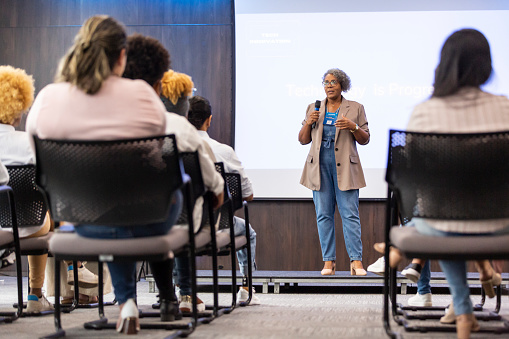 Black woman giving talk to business audience