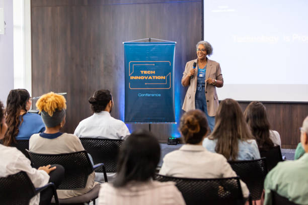 istock Black woman giving talk to business audience 1493549152
