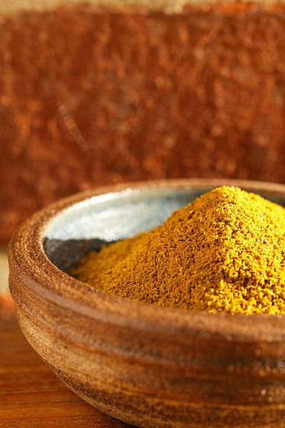 istock hot curry powder spice in bowl , brick wall on background 149355364
