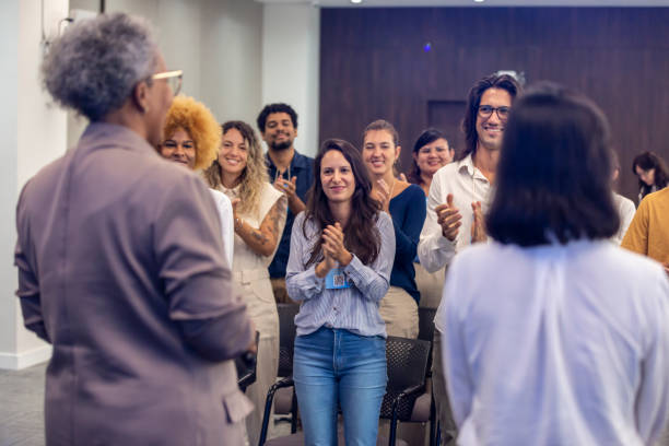 istock People of various ethnicities giving a standing ovation business lecture 1493555515