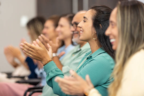 istock Group of women clapping at business conference 1493555609