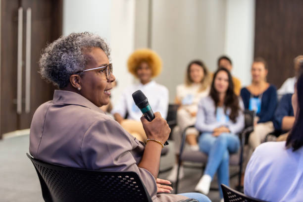 istock Black woman lecturing and audience in the background 1493555612