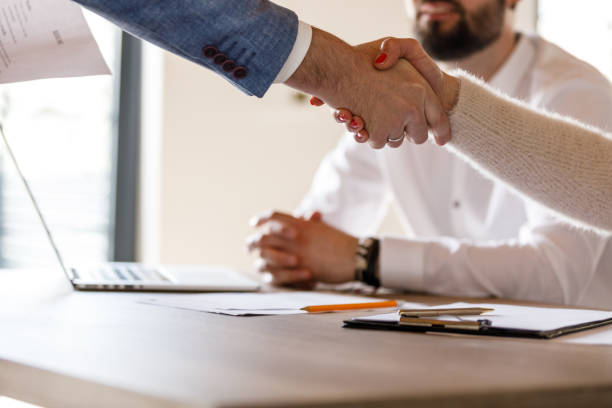 istock Businessman shaking hands with interviewers at the beginning or after a successful job interview meeting 1493557120