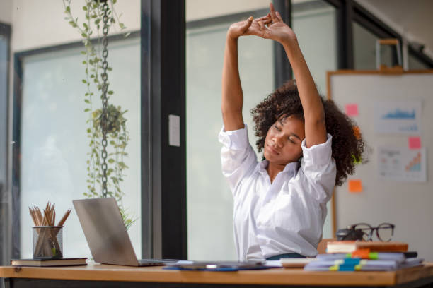 stretch oneself Black woman stretching due to pain from work, tried from work, stretch oneself stretching stock pictures, royalty-free photos & images