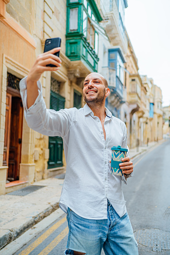 Young smiling tourist man taking selfies in Valletta, Malta