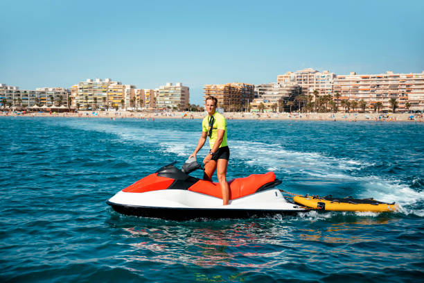 Lifeguard man on summer work Skillfully Maneuvering a Jet Ski
