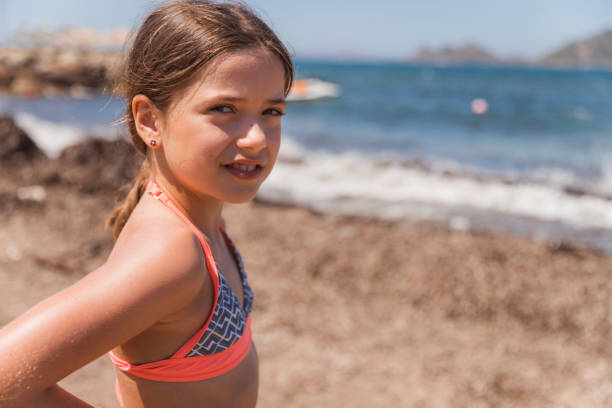 Close-up of a teenage girl on a beach by the sea