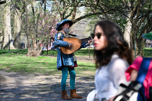 New York, USA, April 13, 2023 - A Troubadour sings in Central Park, Manhattan, New York City.