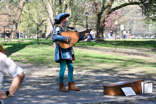 New York, USA, April 13, 2023 - A Troubadour sings in Central Park, Manhattan, New York City.