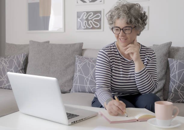 istock Happy trendy middle aged woman remote working 1493568766