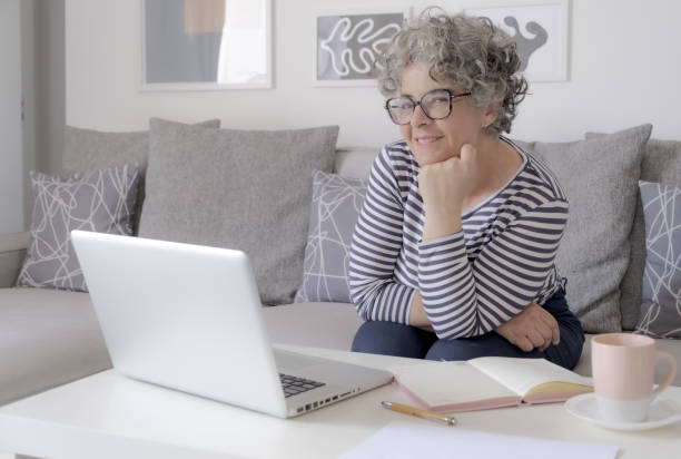 istock Happy trendy middle aged woman remote working 1493568795