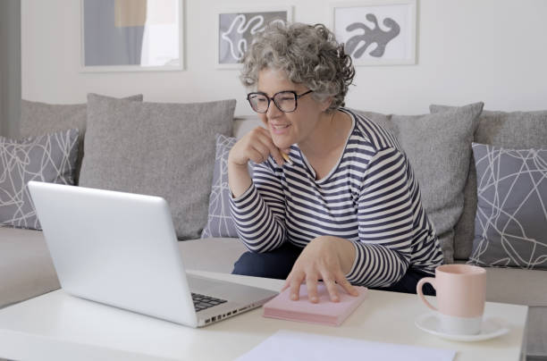 istock Happy trendy middle aged woman remote working 1493569457
