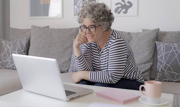 istock Happy trendy middle aged woman remote working 1493569543