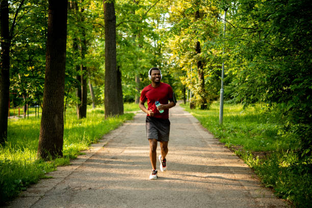 istock Young man is jogging in the park 1493569638