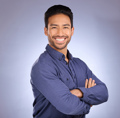 Business man, consultant smile and portrait of a marketing employee from the Philippines in  studio. Isolated, blue background and proud businessman and entrepreneur ready for professional working