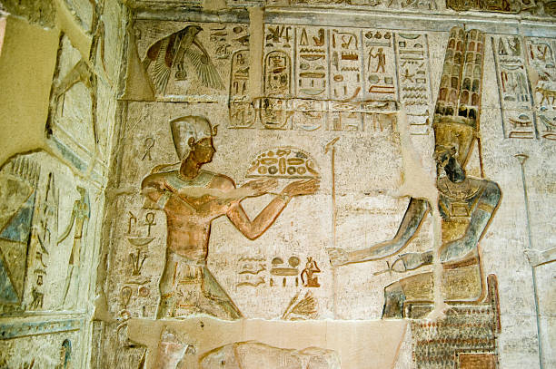 Ptolemy offering to Amun Ancient Egyptian bas relief showing the Pharaoh Ptolemy IV making an offering to Amun.  Deir el Medina temple, Luxor, Egypt. amon photos stock pictures, royalty-free photos & images