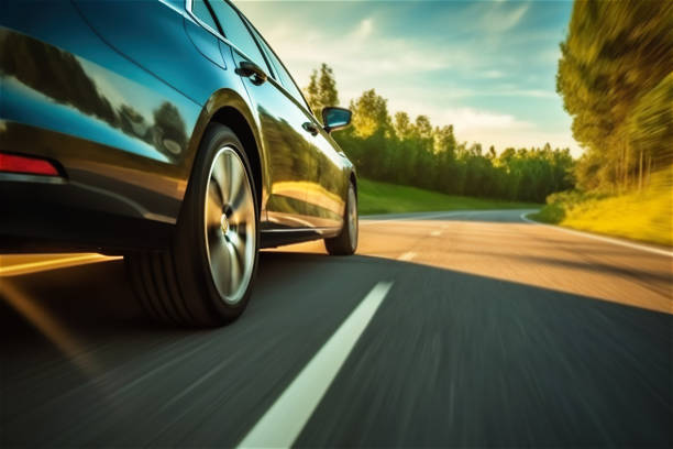 car rushes along the highway at sunset , low angle side view - swerving imagens e fotografias de stock