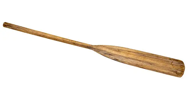 old wooden weathered paddle (oar) with stains and cracks, isolated on white