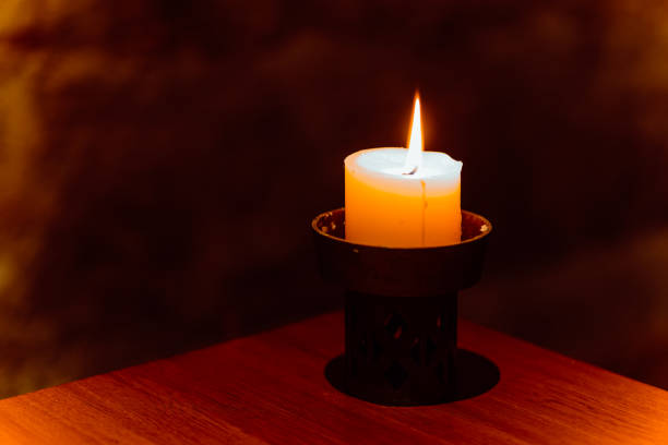istock burning candle in the darkness 1493576359
