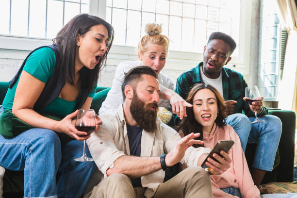 istock Young friends commenting on social media posts with smatphone 1493576412