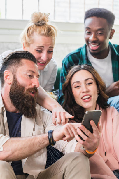 istock Young friends commenting on social media posts with smatphone 1493576416