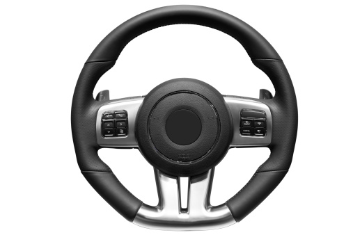 Female sitting inside a car driving with two hands on the steering wheel. Driver traveling alone on the road. Hands on the steering wheel while driving