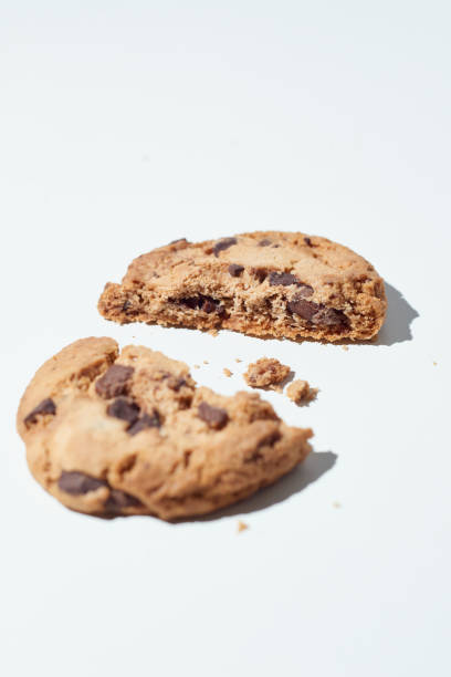 Fresh Chocolate Chip Cookie Broken Into Half on White Background stock photo