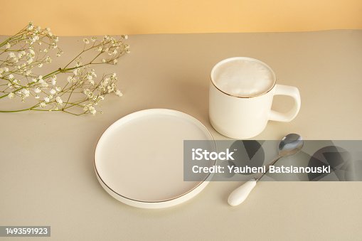 istock white plate empty and mug with cappuccino on a gray background with copy space 1493591923