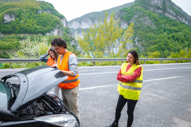 istock Fiends on road trip had a car breakdown and checking car engine 1493593818