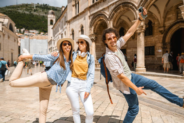 istock Three smiling tourists having fun exploring the city 1493594044