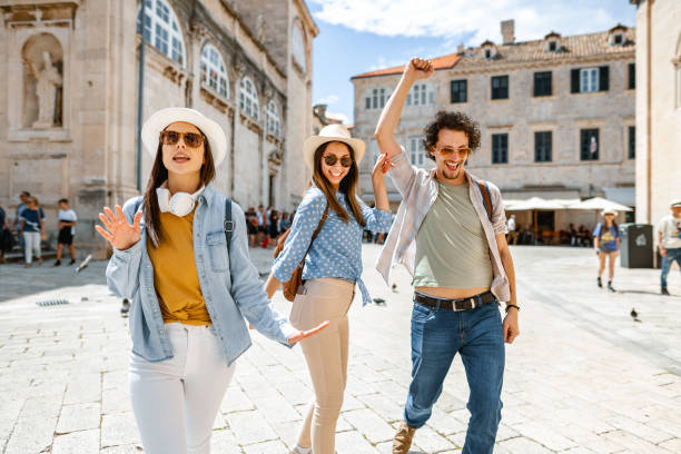 istock Three smiling tourists having fun exploring the city 1493594065