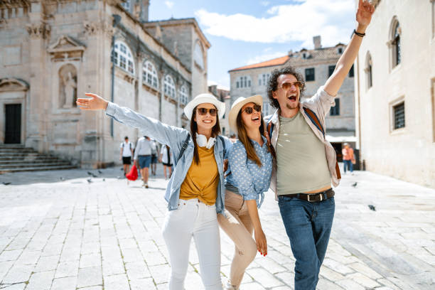 istock Three smiling tourists having fun exploring the city 1493594073