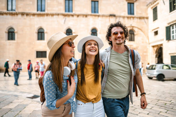istock Three smiling tourists enjoying exploring the city 1493594270