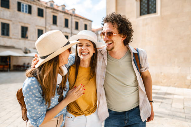 istock Three smiling tourists enjoying exploring the city 1493594281
