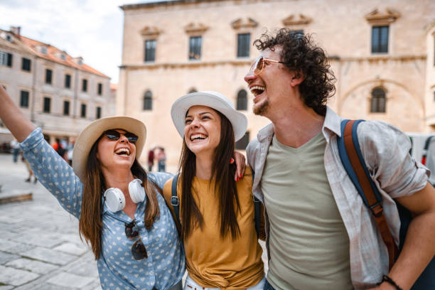 istock Three smiling tourists enjoying exploring the city 1493594305