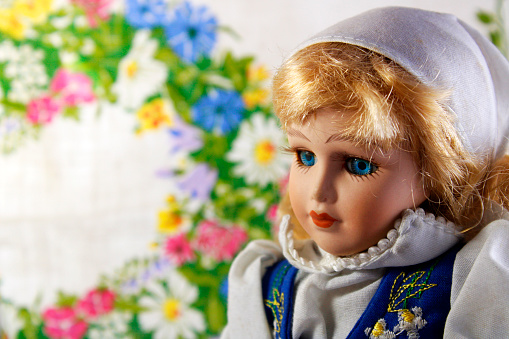 Swedish porcelain doll face with typical dress