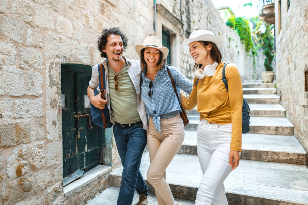 istock Three smiling tourists enjoying exploring the city 1493595000