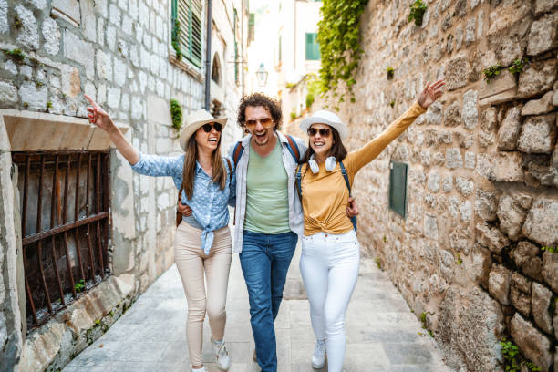 istock Three smiling tourists enjoying exploring the city 1493595079