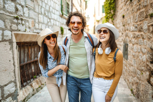 istock Three smiling tourists enjoying exploring the city 1493595125