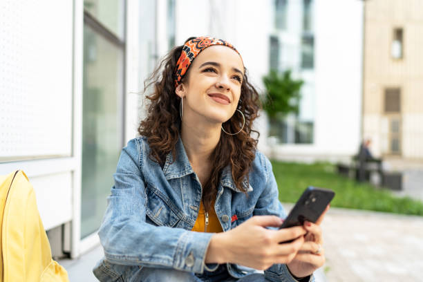 istock Young woman using smart phone outdoors 1493599059